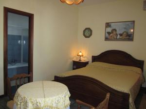 a bedroom with a bed and a table and a clock at Bed&Breakfast Le Valli del Cerrano in Pineto