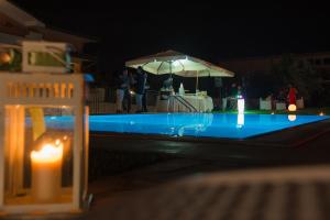 a swimming pool at night with a table and an umbrella at Villa Emilia in Fossacesia