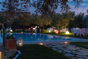 a backyard with a swimming pool at night at Villa Emilia in Fossacesia