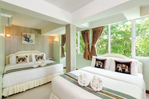 Postel nebo postele na pokoji v ubytování RoomQuest Suvarnabhumi Airport Romklao Soi 6 + 37 fotografií