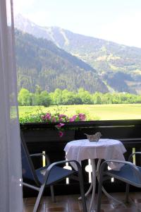 a table and chairs with a view of a mountain at Haus Schnetzer in Schruns-Tschagguns