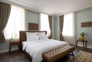 a bedroom with a large white bed and windows at Carmella Spa & Boutique Hotel in Haifa +37 photos