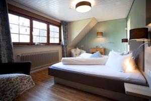 a bedroom with a bed with white sheets and pillows at Freiämter Hof in Freiamt