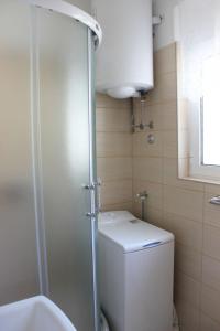 a small bathroom with a toilet and a shower at Apartmani Vinko Bol in Bol +47 photos