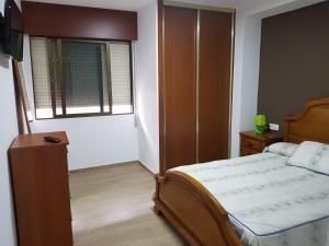 Giường trong phòng chung tại Apartamento Bueu Familiar