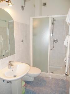 a white bathroom with a sink and a shower at Girasole House in Florence