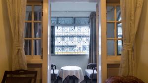a view of a room with a table and a window at Bed and Breakfast at Colaba in Mumbai
