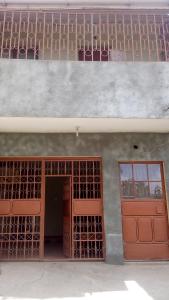 a building with a red door and a window at Juddy Place in Nairobi