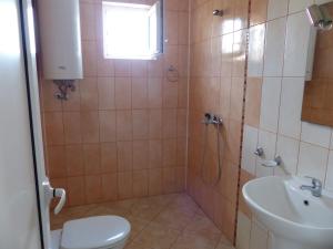 a bathroom with a shower and a toilet and a sink at Studio S - Vasiliko in Tsarevo