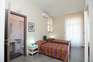 Albergo San Maurizio tesisinde bir odada yatak veya yataklar