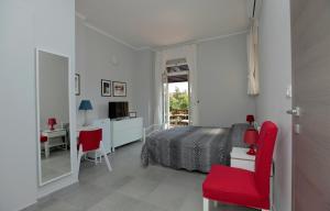 1 dormitorio con 1 cama y escritorio con silla roja en Albergo San Maurizio en Turín