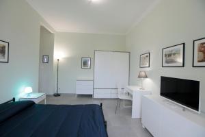 a bedroom with a bed and a flat screen tv at Albergo San Maurizio in Turin