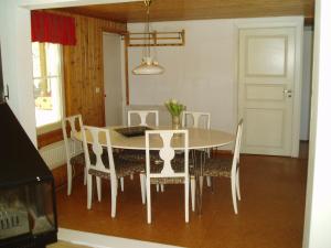 comedor con mesa blanca y sillas en Peaceful nature retreat, en Björnlunda