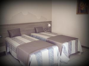 Postel nebo postele na pokoji v ubytování Hotel I Pini