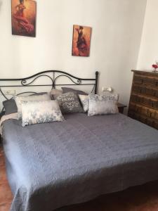 a bedroom with a bed with blue sheets and pillows at Todosol Dream in Águilas
