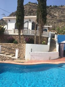 a house with a swimming pool in front of a house at Todosol Dream in Águilas