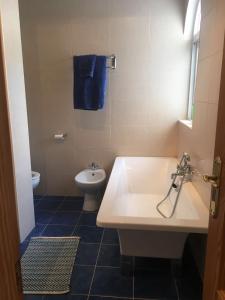 a bathroom with a white sink and a toilet at Todosol Dream in Águilas