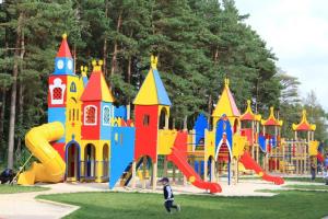 a childrens playground with a colorful play structure at Vila Medus in Palanga