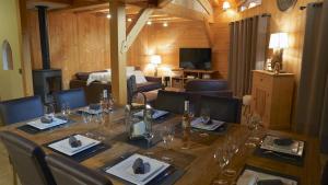 a dining room with a long table and chairs at LES 3 CIMES BLANCHES in Chamonix