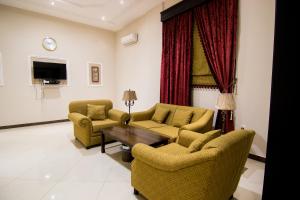 a living room with two chairs and a table at Shaza Al Khamis شذا الخميس in Khamis Mushayt