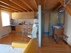 a kitchen with a table and chairs in a room at Sorta Apartments in Kato Daratso