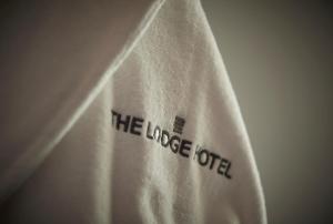 a white towel with thelee hotel written on it at The Lodge Hotel - Putney in London