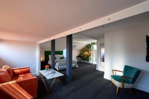 un soggiorno con divano e letto di The Lodge Hotel - Putney a Londra