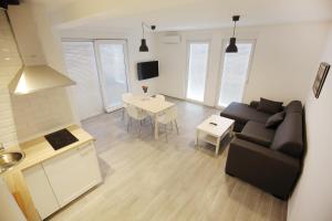 a living room with a couch and a table at Apartments Villa Navi in Bibinje