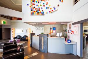 una hall di una clinica con sedie e bancone della reception di Hôtel & Résidence Octel a Portet-sur-Garonne