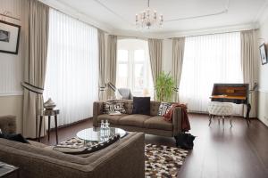 a living room with a couch and a table at Hotel Stralsund in Stralsund