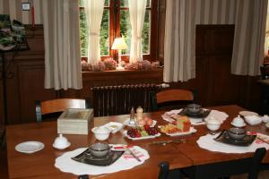 a dining room table with dishes of food on it at Château de Bonne Espérance in Huy