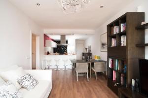 a living room with a white couch and a table at Vilamarlux I in Vilassar de Mar