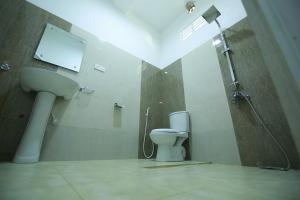 a bathroom with a toilet and a shower and a sink at Weligama Watergate in Weligama +53 photos