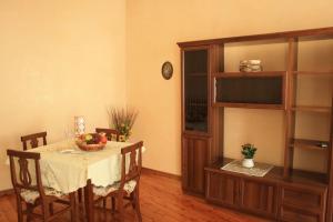 a dining room with a table and a shelf at B&B Rosa Apartment in Baveno
