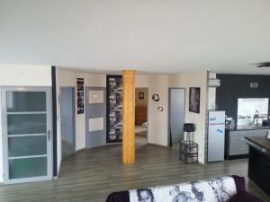 a living room with a couch and a kitchen at Loftcosy Friville in Friville-Escarbotin