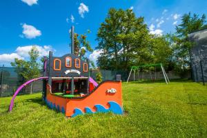 a toy boat on the grass in a park at Apartament Morski in Ustronie Morskie