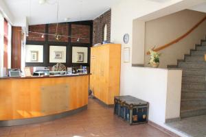 a lobby with a counter and stairs in a building at Hotel und Restaurant Eurohof in Duisburg