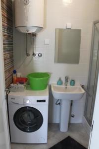 a bathroom with a washing machine and a sink at Apartments Grgurević in Kotor +65 photos