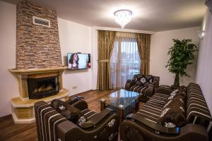 a living room with couches and a fireplace at Boutique Apart Hotel Versis in Sunny Beach