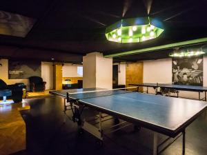 a ping pong table in a room with ping pong tables at Amstel House Hostel in Berlin