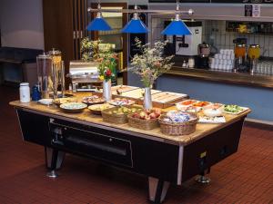 a buffet of food on a table in a kitchen at Amstel House Hostel in Berlin