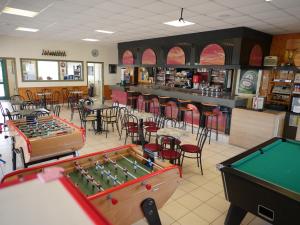 a restaurant with two pool tables and chairs at Camping Paradis Le Royon in Fort-Mahon-Plage