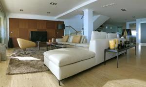 a living room with a white couch and a table at Seaside Villa in Alicante