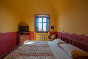 Postel nebo postele na pokoji v ubytování B&B La Pulce Dorata