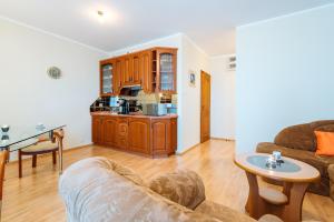 a living room with a couch and a table at Apartament Morski in Kołobrzeg