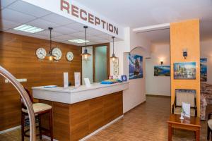 a restaurant with a reception counter in a room at Hotel Central in Sunny Beach