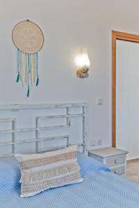 a bedroom with a blue bed with a head board at Alisachni Villas in Lefkos Karpathou