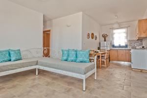 a living room with a couch and a kitchen at Alisachni Villas in Lefkos Karpathou