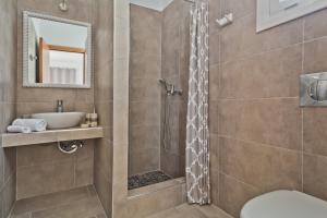 a bathroom with a shower and a sink at Alisachni Villas in Lefkos Karpathou