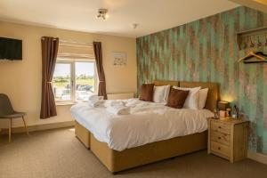 a bedroom with a large bed and a window at The Sail Loft in Southwold
